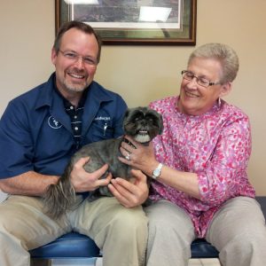 The doctor and a pet owner with her pet Grace