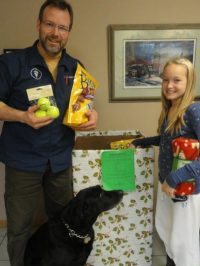The vet and his daughter with the donations for presents for pets